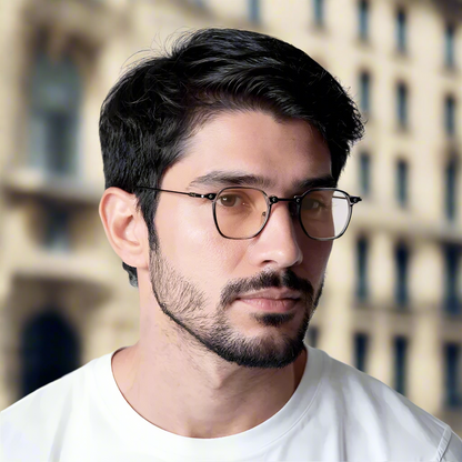 Man wearing glasses with a neutral background